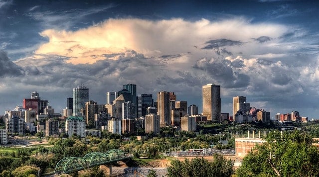 city skyline under blue and white sunny cloudy sky during daytime